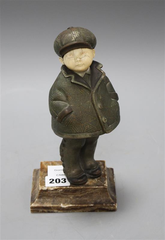 An Art Deco silver overlaid bronze and ivory figure of a boy wearing winter coat and cap, overall height 22cm, height of figure 19cm